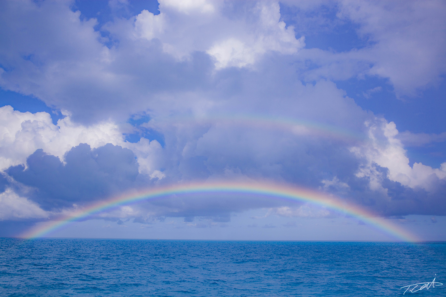 Rainbow on the blue ocean.